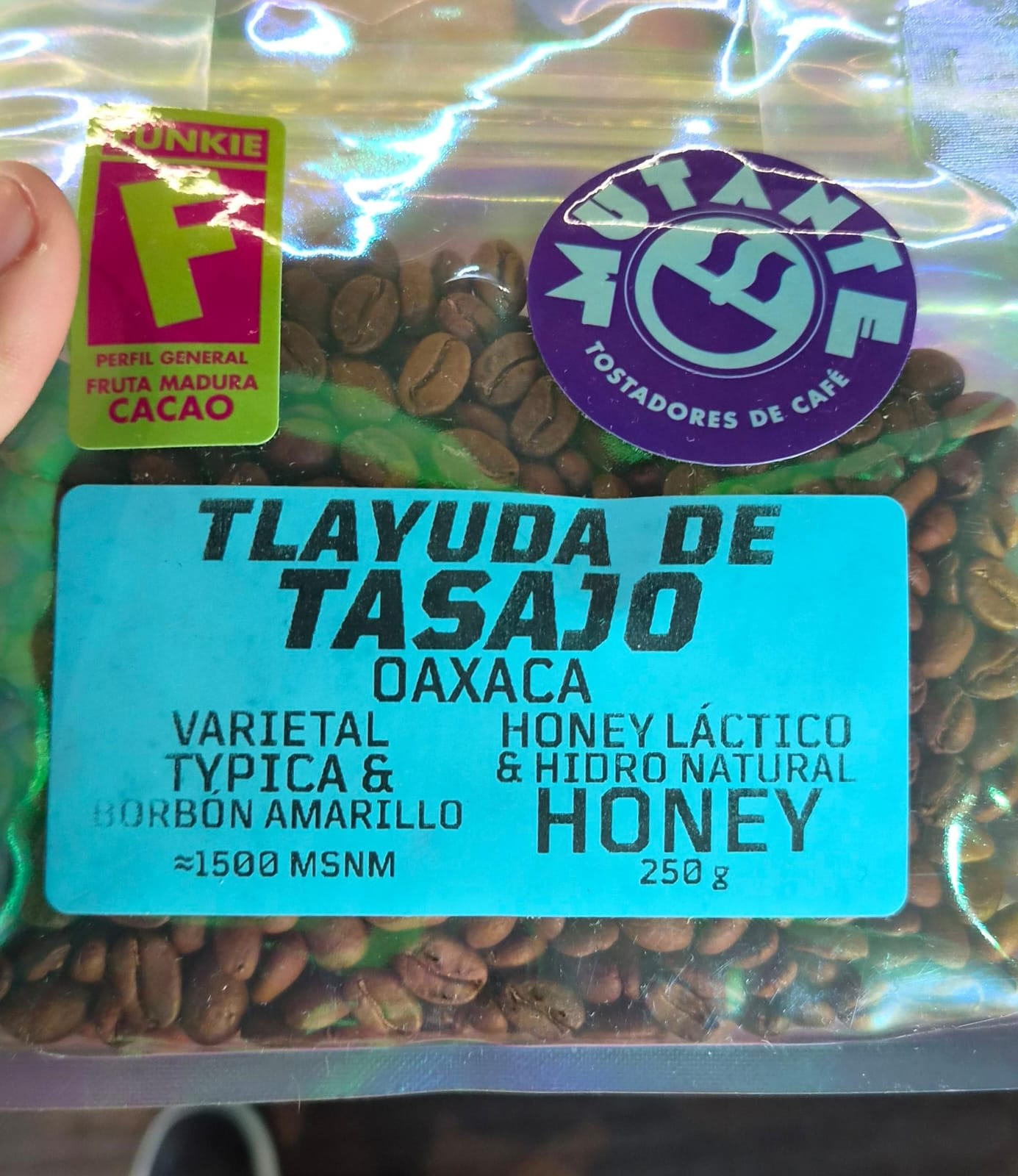A close-up of a bag of coffee beans labeled as Oaxaca honey-process coffee.